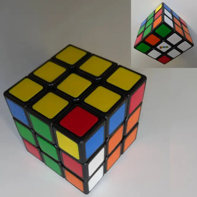 Close-up of a Rubik's Cube during the final corner orientation step with scrambled lower layers